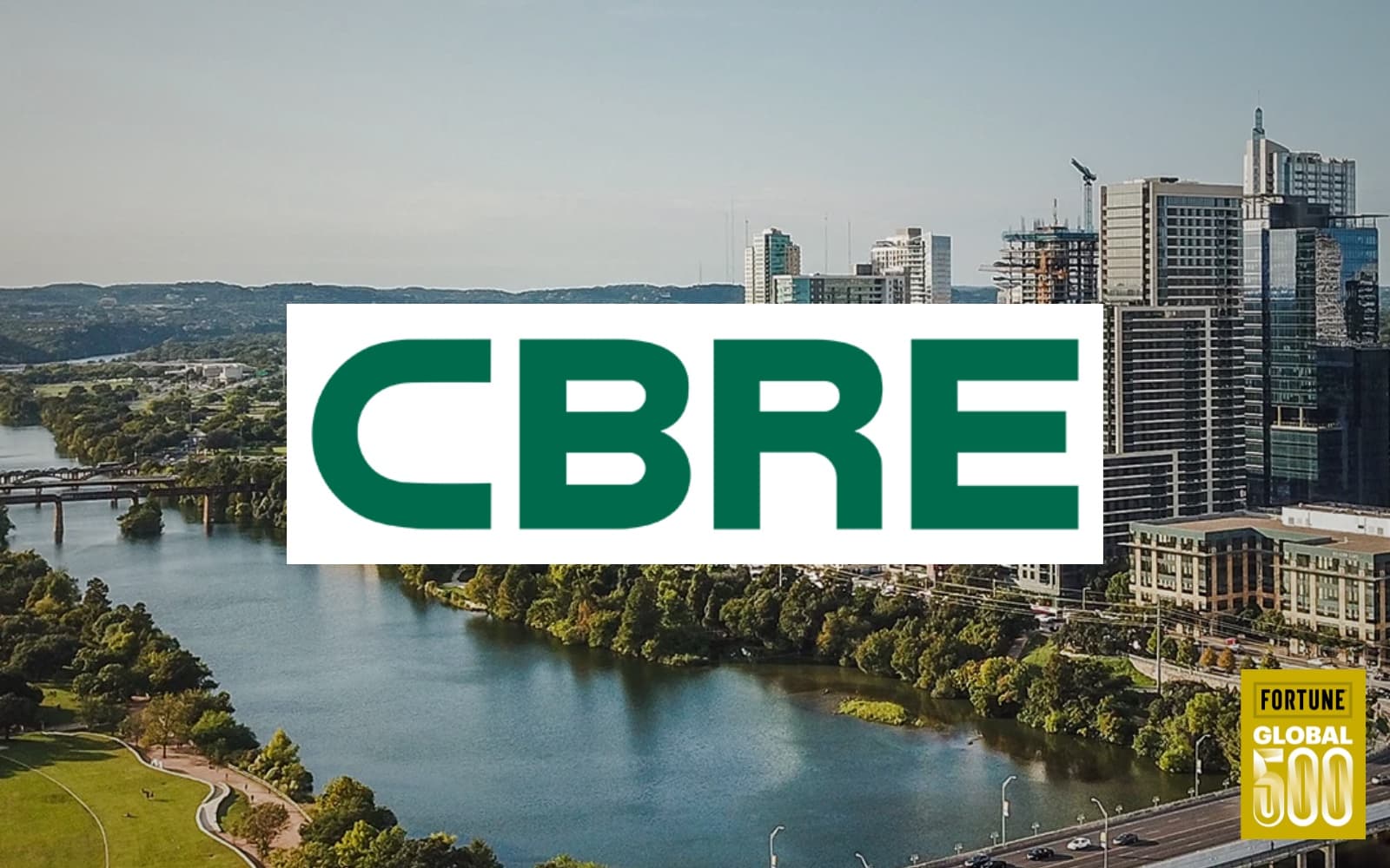 Aerial view of the Austin skyline along Lady Bird Lake with the CBRE logo overlaid